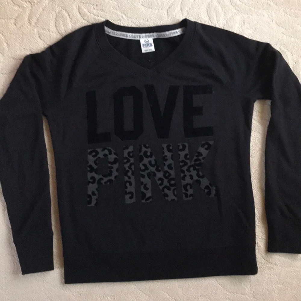 Pink v-neck sweatshirt.